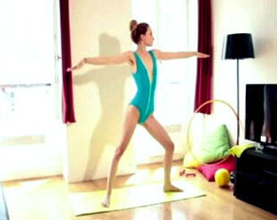 Teenage gymnast dame practising yoga in bathing suit at